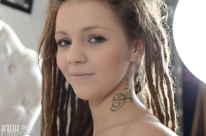 Tattooed teen with dreads enjoys posing nude