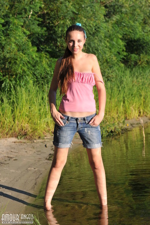 Brown haired teen gal posing outdoors with joy