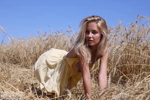 Busty blonde gal showing her boobs outdoors