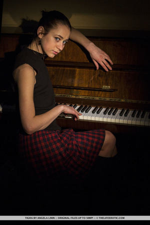 Girl shows off her body after a piano session.