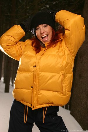 Red hair hanging out of her skull cap she masturbates without a bottom in the snow