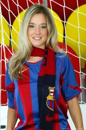 In a net ass covered in a barcelona scarf she smiles looking back