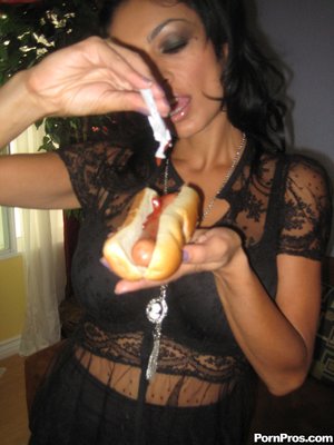 Sexy raven enjoys eating her hotdog sandwich and big black cock