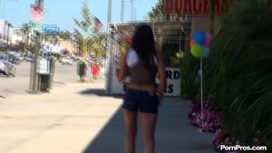 Beautiful brunette showcases her smoking hot curves while strolling in public