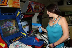 Playful brunette enjoys playing and getting fucked at the arcade