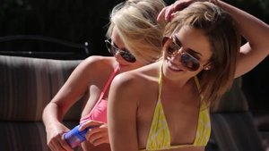 Two college babes enjoys a nice threesome fuck by the pool