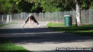 Brunette, dressed in workout clothing, she stretches before a run