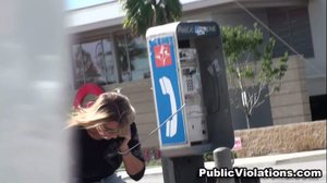 Older and blonde, on a payphone, she hangs out on a corner in jeans