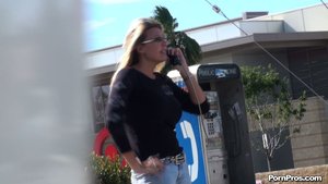 An older whore, with long blonde hair, talks on the phone