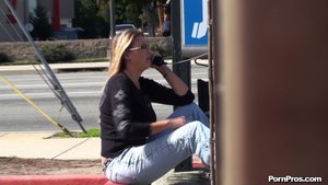 An older whore, with long blonde hair, talks on the phone