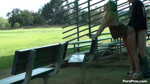 Green hair draped down her back, she purses her lips as her bends her over the bench