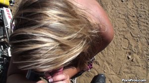 Smiling brightly, as cum drips down this blondes' tits, she kneels in the sand