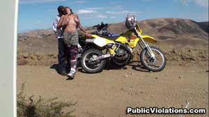 Out in the arid desert, she sucks cock while kneeling in front of a dirt bike