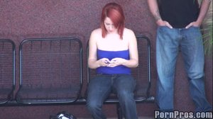 Wearing a blue tube top and jeans, this sexy whore sits in a public place
