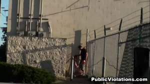 Grabbing hold of a chain-link fence, he spreads her legs for a chubby guy, dropping his pants