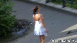 Following a gorgeous tramp, in a white dress, the camera catches her movements from afar