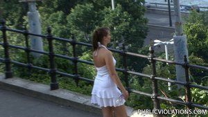 Following a gorgeous tramp, in a white dress, the camera catches her movements from afar