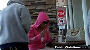 Blonde, in a pink hoodie, she gets splashed while texting on her phone