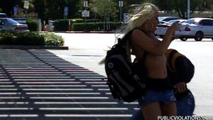 Coming out of no where, he yanks this blondes' tube top down around her waist