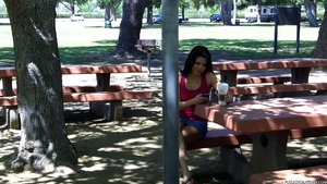 He stalks her in a park, watching as she relaxes at a picnic table, niaeve