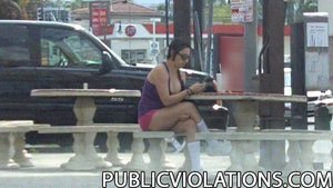 Chubby, in purple and pink, she hangs out in a public place, being filmed from a distance