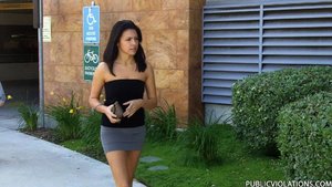 Sporting a tight black tube top and a tiny skirt, this brunette gets followed