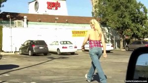 Tall and blonde, she struts around town, showing off her large tits