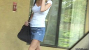 Strutting around in a denim skirt, she shows off her sexy body