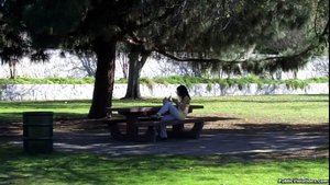 Hanging out in a park, she lounges on a bench, being stalked with a camera