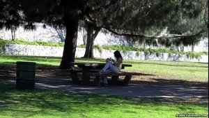 Hanging out in a park, she lounges on a bench, being stalked with a camera