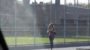 A stranger streaks by, exposing her large tits to the public