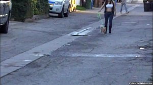 Chubby with a white tube top, she walks down the road, with her dog