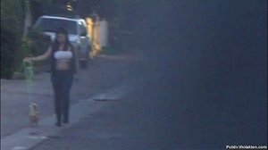 Chubby with a white tube top, she walks down the road, with her dog
