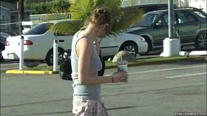 Dressed in gray, tits flopping, as he films her moving around