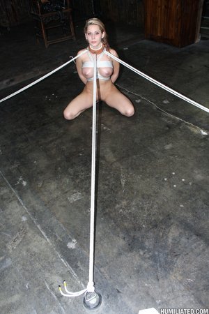 Tied up with rope, she gets her lips stretched and mouth filled with cum